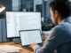 Professional using AI email management tool on laptop to organize flooded inbox